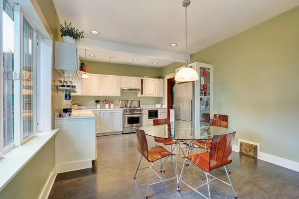 View of dining table set and kitchen storage combination. — Stock Photo, Image