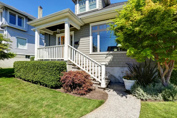 Craftsman house porch with square columns and staircase