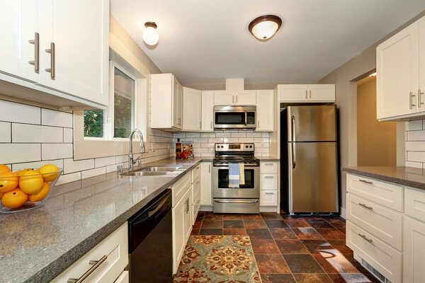 Simple yet practical kitchen interior with white cabinets