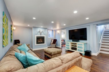 Pastel blue walls in basement living room interior. clipart