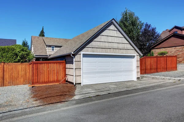 White door garage and fenced back yard. — Stok fotoğraf