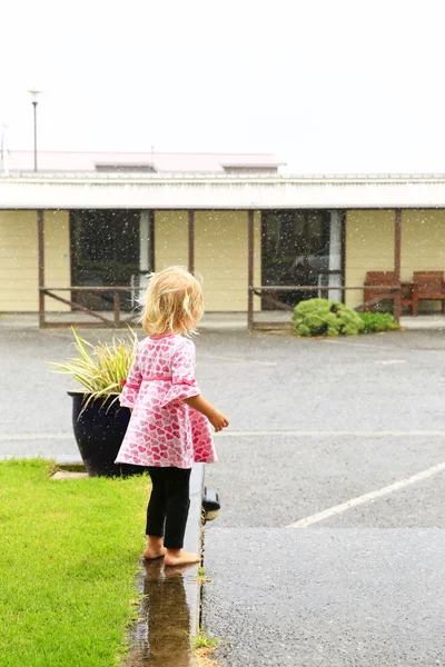 Foto de niña de pie bajo la lluvia en Greymouth, Nueva Zelanda —  Fotos de Stock