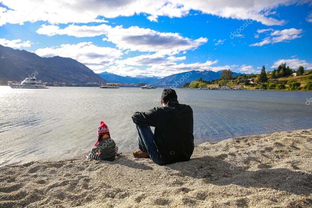 Father with little daughter appreciate Lake Wanaka landscape in New Zealand