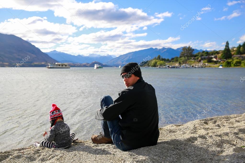 Father with little daughter appreciate Lake Wanaka landscape in New Zealand