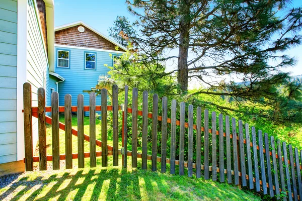 County style long wooden fence with gate.