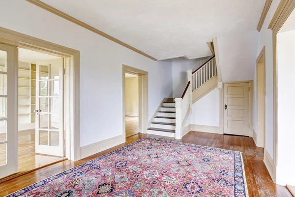 Intérieur du couloir dans des tons blancs avec plancher et tapis en bois franc . — Photo