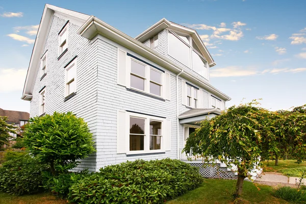 Traditional three story house exterior with well kept garden around. — Stock Photo, Image