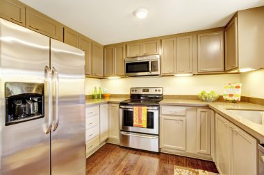 Kitchen room interior in beige tones with hardwood floor clipart