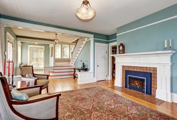 Traditionele woonkamer interieur in blauwe en witte tinten, open haard en tapijt — Stockfoto