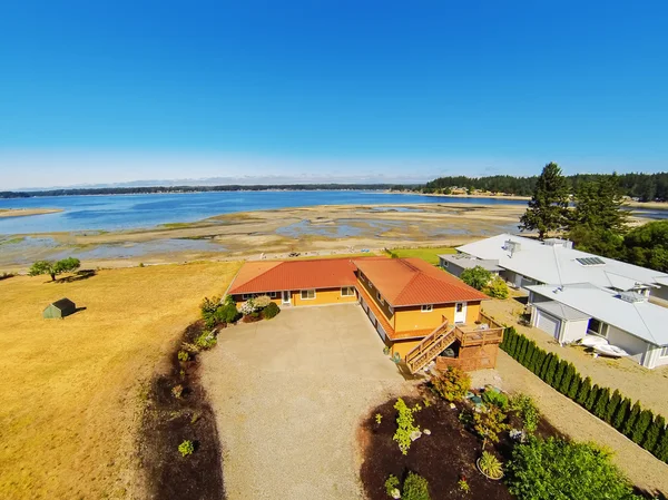Aerial view of waterfront house with perfect landscape.