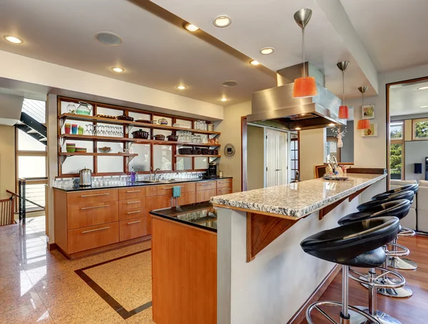 Interior de la cocina con largos gabinetes de madera y estantes . — Foto de Stock