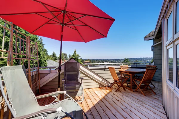 House balcony with wooden table set, folding chairs — Stock Photo, Image