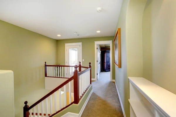 Mint upstairs hallway with white railings — Stock Photo, Image