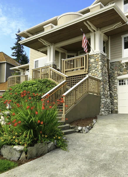 House with stone trim and deck — Stock Photo, Image