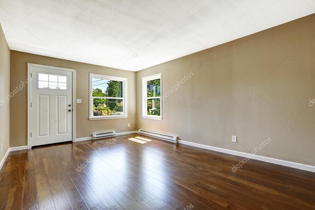 Empty house interior. Hardwood floor and beige walls. 