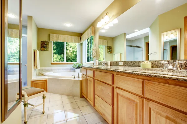 Bright bathroom with corner bath tub — Stock Photo, Image