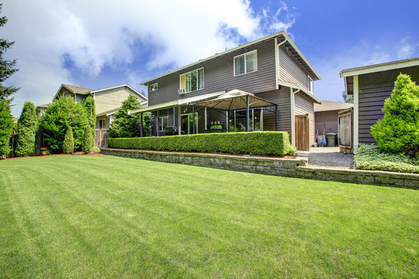 House exterior with lawn and trimmed hedges