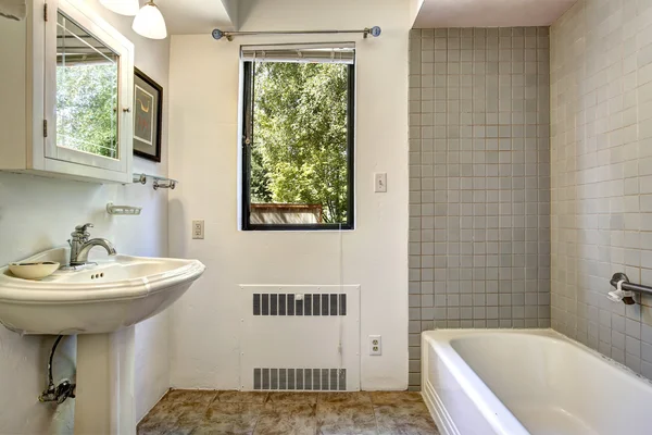 Old bathroom with grey tile wall trim — Stock Photo, Image