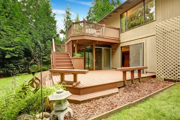 Wooden walkout deck with patio and benches — Stock Photo, Image