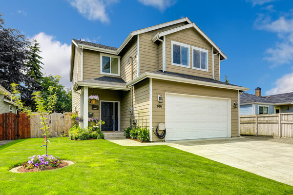 Two story house exterior with front yard landscape