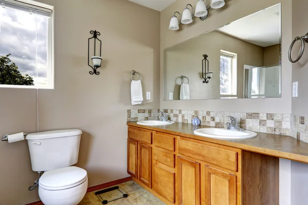 Bathroom cabinet with two sinks and tile trim — Stock Photo, Image