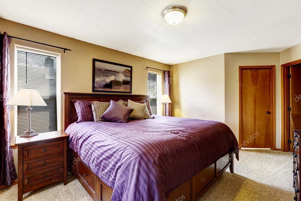 Luxury Bedroom Furniture With Bright Purple Bedding Stock