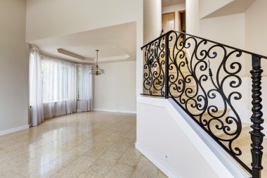 Emtpy house interior. Marble staircase with black wrought iron r clipart