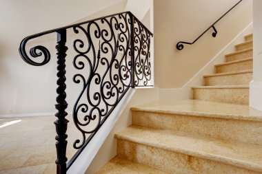 Marble staircase with black wrought iron railing clipart