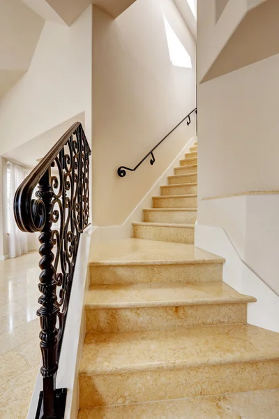 Marble staircase with black wrought iron railing — Stock Photo, Image