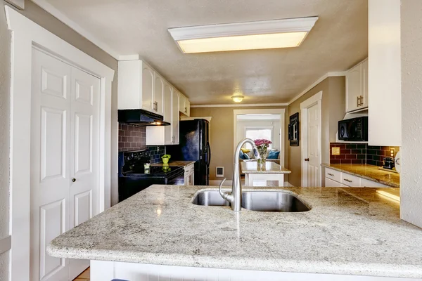 Kitchen cabinet with granite top and steel sink — Stock Photo, Image