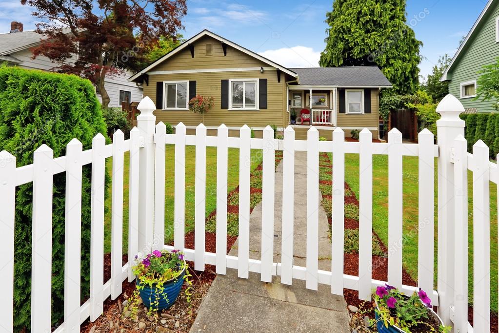 American house exterior with white closed wooden gate