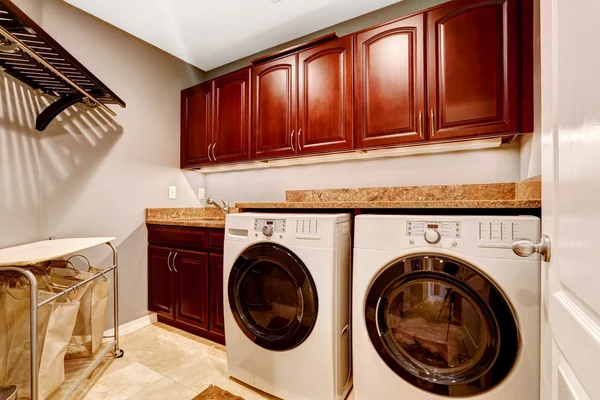 Modern laundry room with cabinets and granite top — Stock Photo, Image