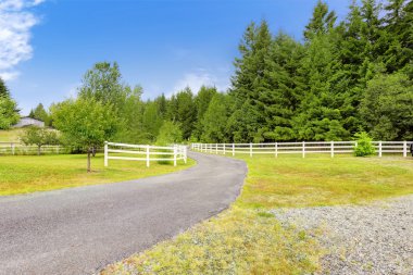 Farm driveway with wooden fence in Olympia, Washington state clipart