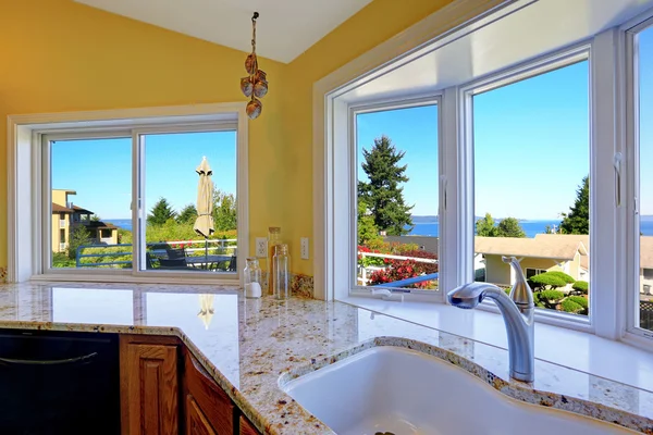 Kitchen cabinet with granite tops and beautiful window view — Stock Photo, Image