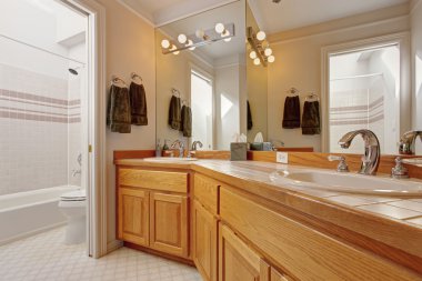 Bathroom vanity cabinet with two sinks and mirror clipart
