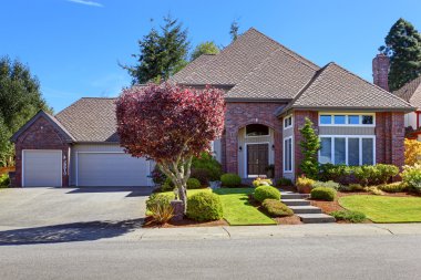 Luxury house with brick wall trim and beautiful curb appeal clipart