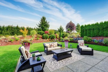 Impressive backyard landscape design with patio area clipart