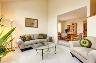 Luxury family room in soft creamy tones and maple dining table s