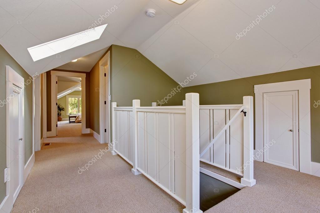 Green And White Upstairs Hallway With Vaulted Ceiling And