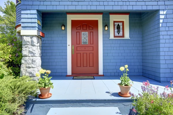 Blue entrance porch with red door. — Stock Photo, Image