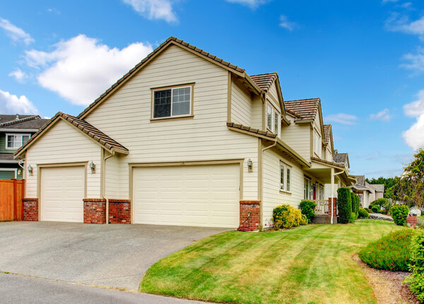 Large house with garage and driveway. 