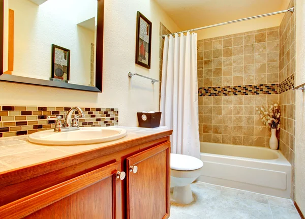 Bathroom interior with beige tile wall trim — Stock Photo, Image