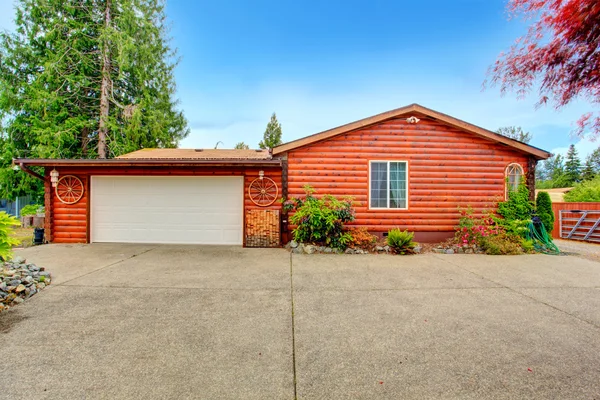 Log cabin style house exterior with garage. — Stock Photo, Image