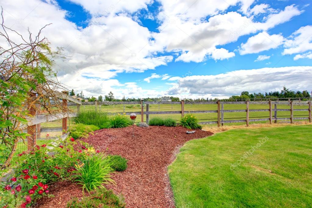 Farm house front yard landscape with sawdust flower bed