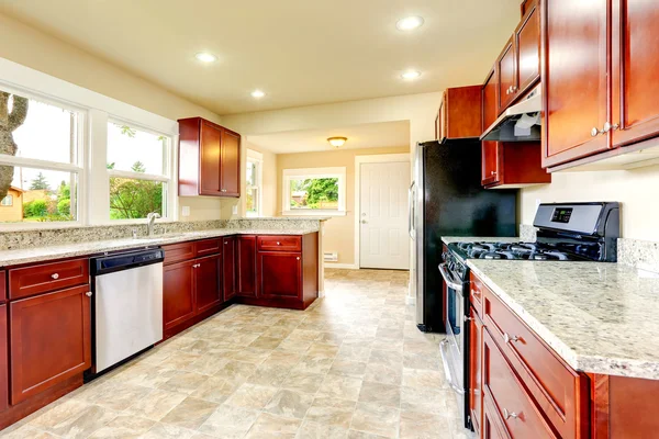 Bright kitchen room with black and steel appliances — Stock Photo, Image