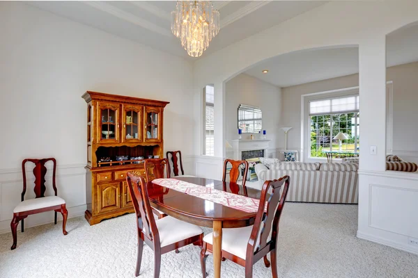 Bright dining room with carved wood cabinet — Stock Photo, Image