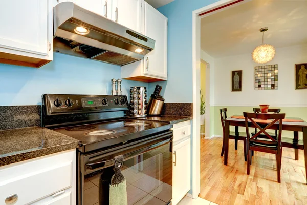 White kitchen cabinets with black stove — Stock Photo, Image