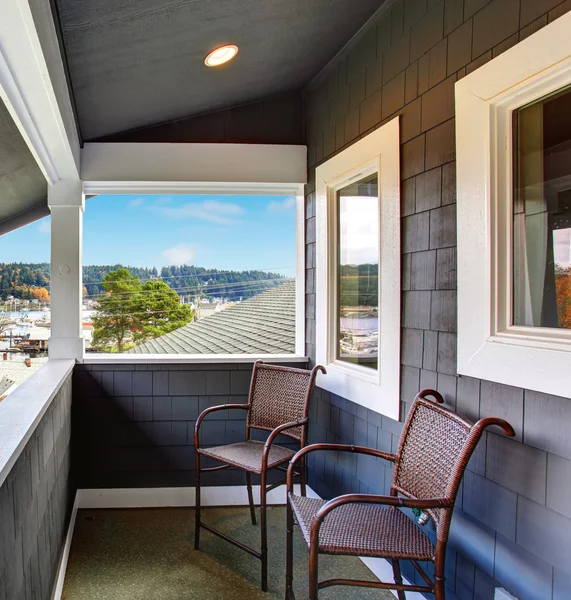 Covered porch of the blue siding home with two chairs. — Stock Photo, Image