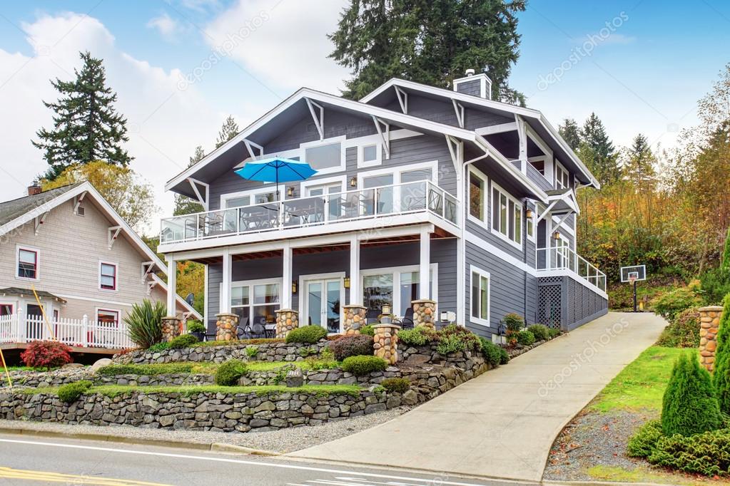 Large gray modern house and garage.