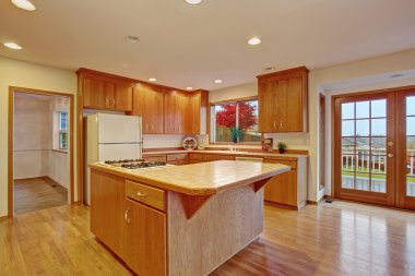 Classic hardwood kitchen with connected living room.